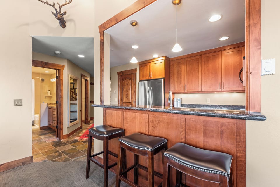 The well-equipped kitchen has a breakfast bar with seating for four guests..