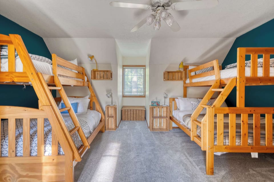 Bedroom with two wood bunk beds and a window.