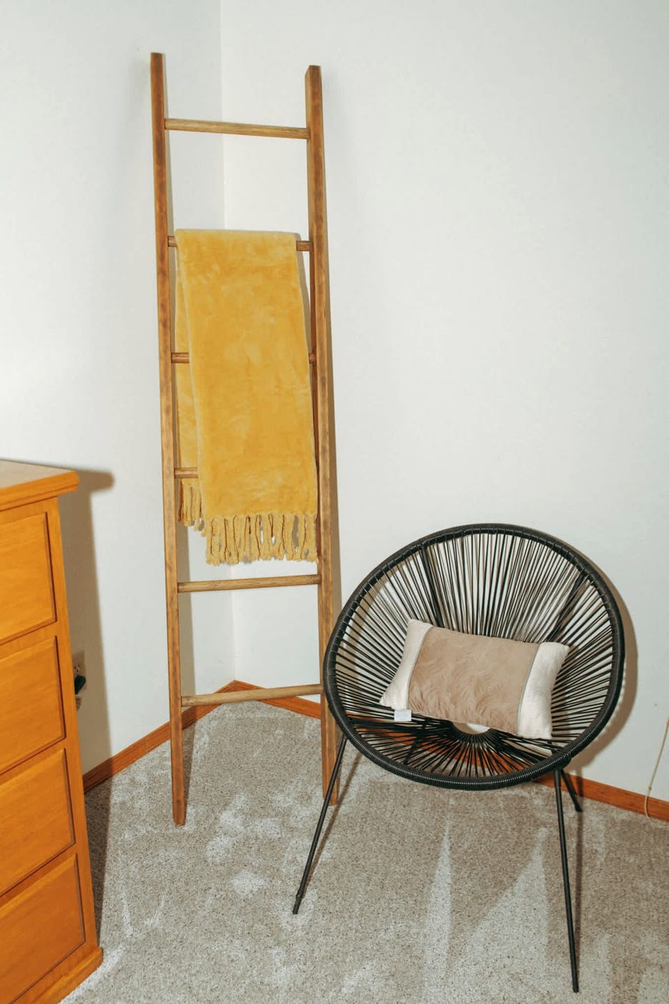 Bedroom 1 reading chair and dresser.