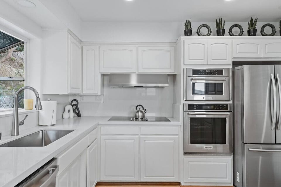 Bright full kitchen with counter stools