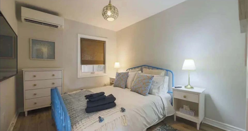 Queen bedroom with smart TV and A/C