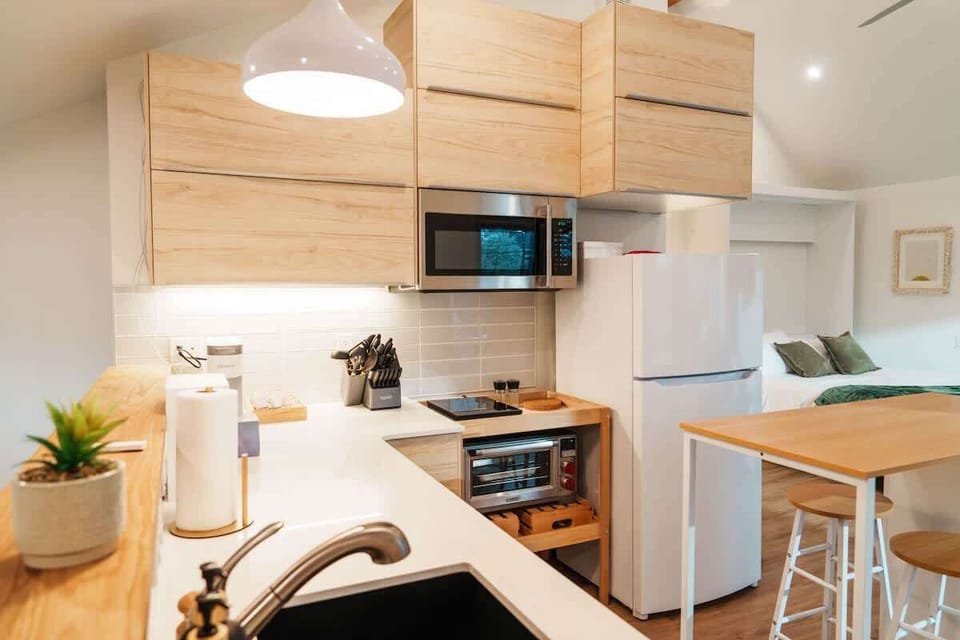 Full kitchen with island seating - perfect for working, sipping, or just hanging out while someone’s cooking.