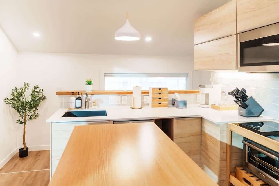 Kitchen island doubles as a prep station and a casual hangout spot for meals or conversation.