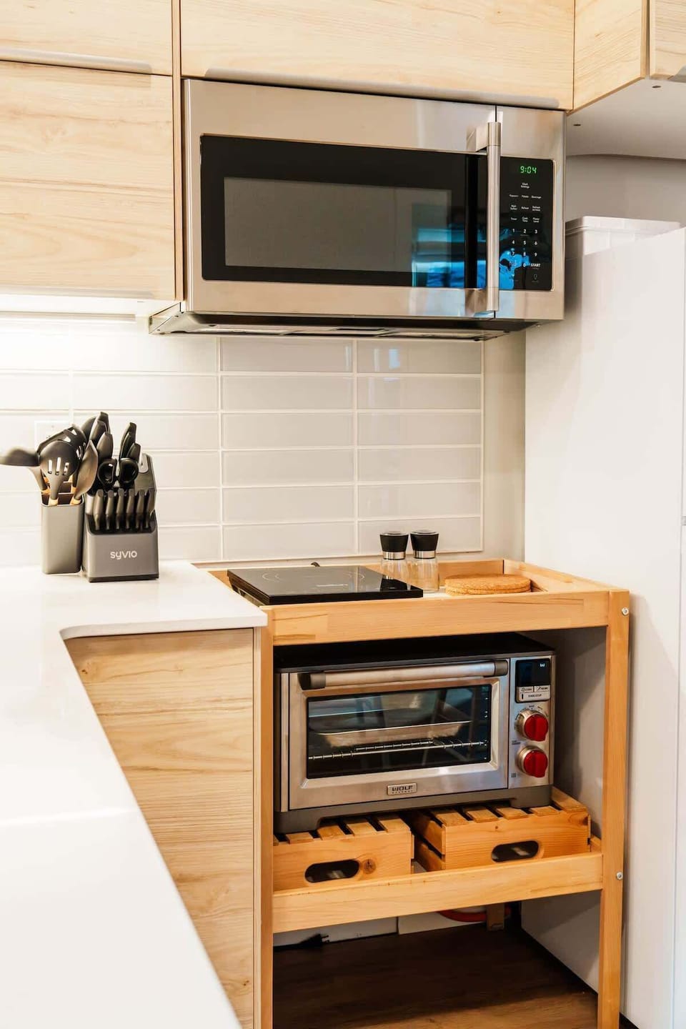 Compact but complete - microwave, cooktop, fridge, and everything you need to make a real meal.