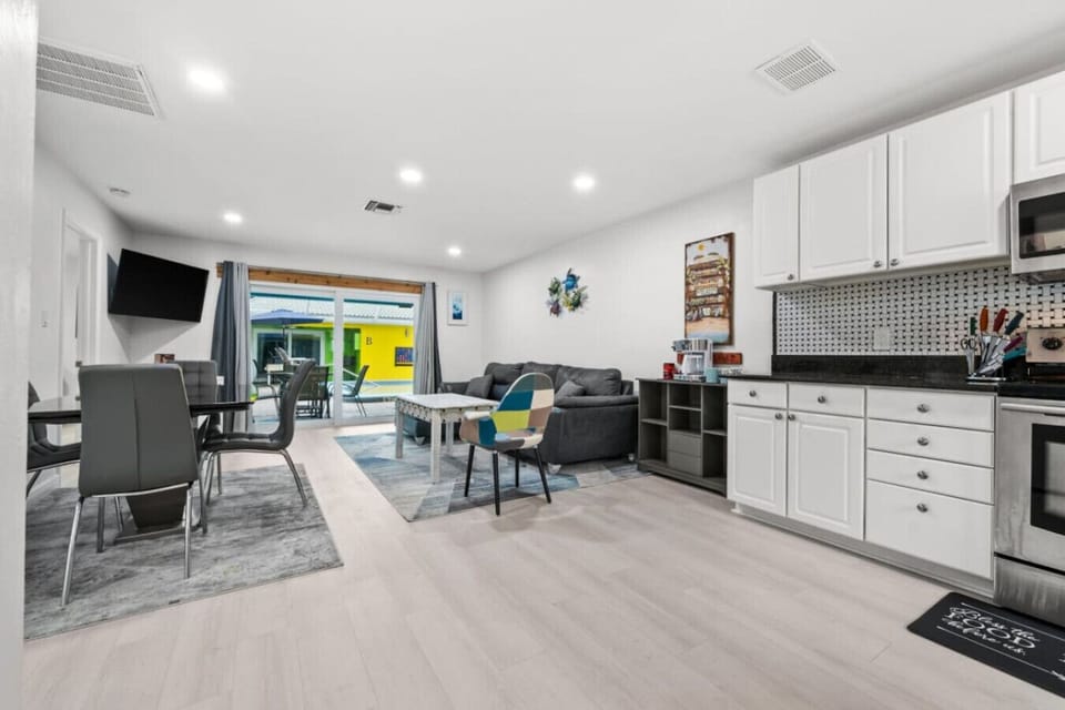 Unwind and savor a refreshing drink at the kitchen island while you take in the beauty of this well-equipped modern kitchen.