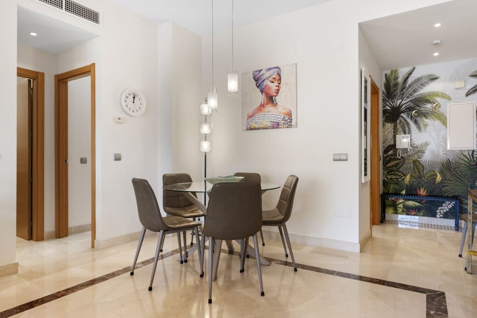 Spacious living room with large Smart TV, sound system, seating area, dining area, central AC