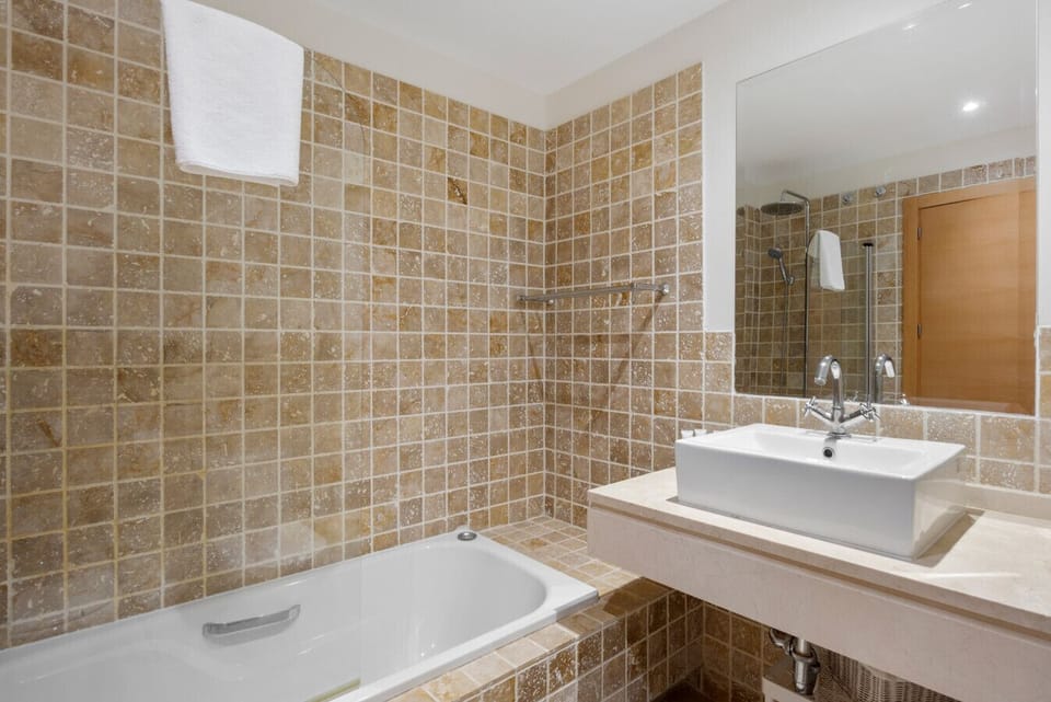 Master bedroom en-suite bathroom with shower over bath