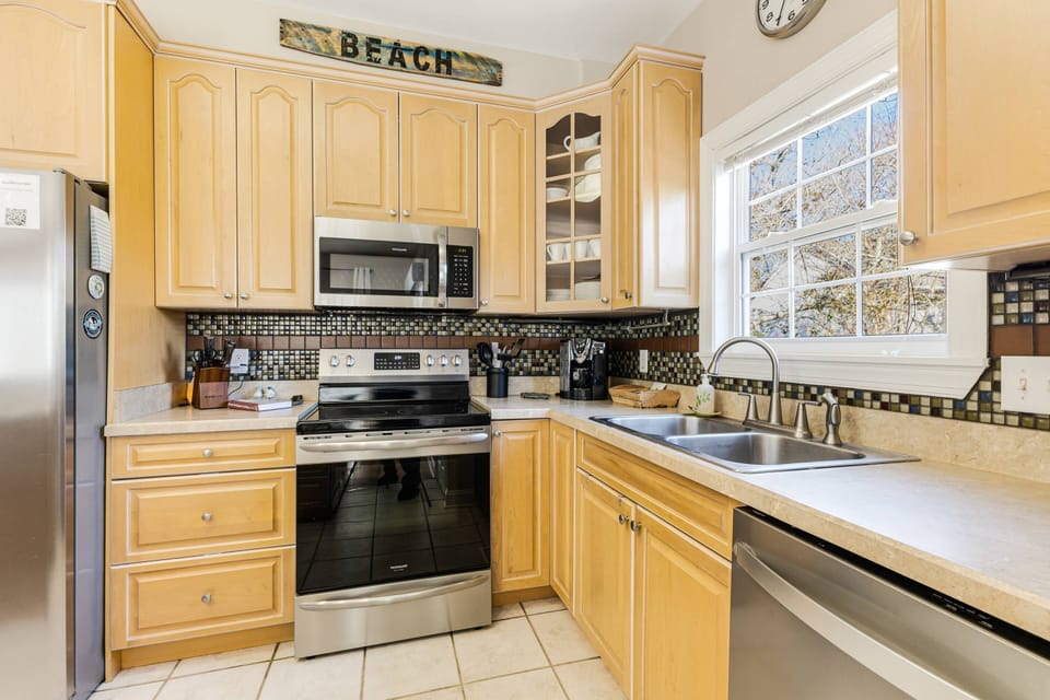 The kitchen is fully stocked with modern appliances and all the essentials for effortless meal prep.