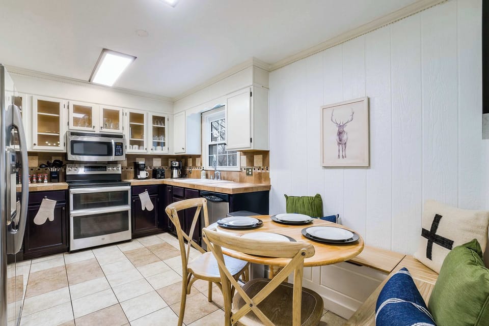 Enjoy meals together at the dining table, conveniently located beside the kitchen for easy serving and quality time.