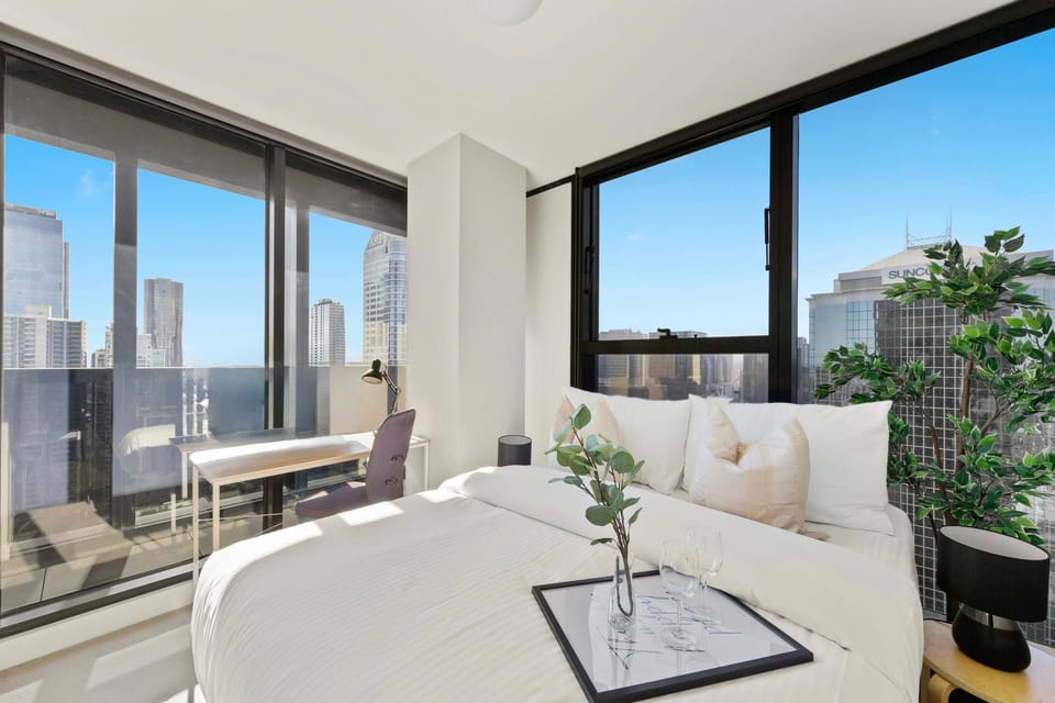The master bedroom with a queen sized bed & city views.
