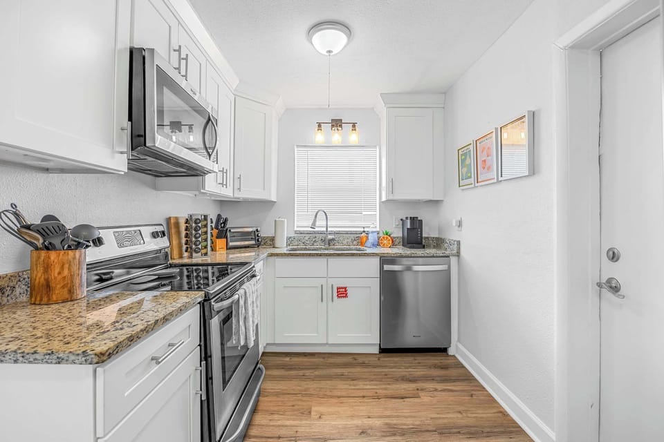 Modern kitchen with stainless steel appliances and granite countertops
