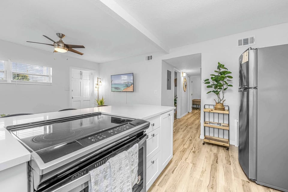 Modern kitchen with stainless steel appliances and wood flooring