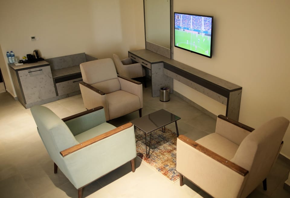 Junior Suite | Living area | 50-inch Smart TV with satellite channels