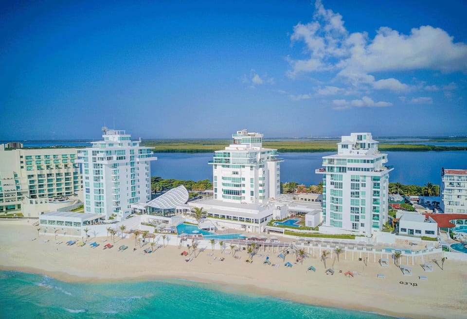 Aerial view of the resort, Oleo Cancun Playa.  Penthouse Combo #334 is located in the North tower, right, on the top floor, 7th. Between both units, you have the top 2 Floors of the Entire West Side of the Tower. Unit 1: 4BR/3.5Bth, Unit 2:4br/4.5bth