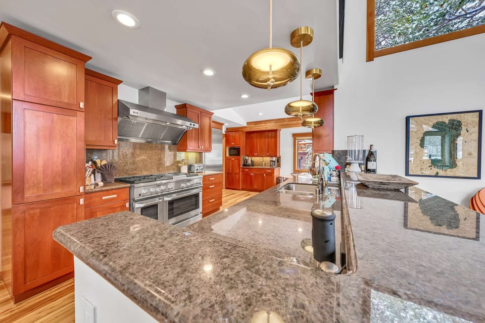 Kitchen: Drip coffee maker, Nespresso, Crockpot, blender, stand mixer, 2 sinks, food-warming drawers, 9-burner stove with griddle, double oven, sub-zero fridge, cooking utensils, tableware