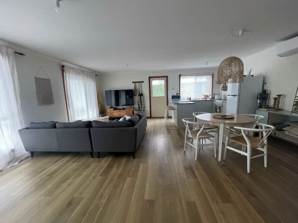 View from hallway/bedrooms. Space behind sofa fits a queen air mattress easily!