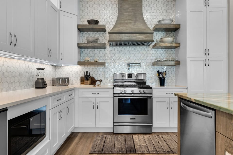 Cook your favorite meals in this stunning modern kitchen with premium appliances and elegant tile backsplash.