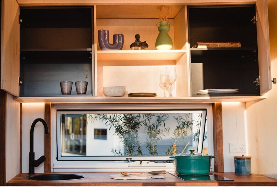 Kitchen with all cooking utensils, pots pans and more.