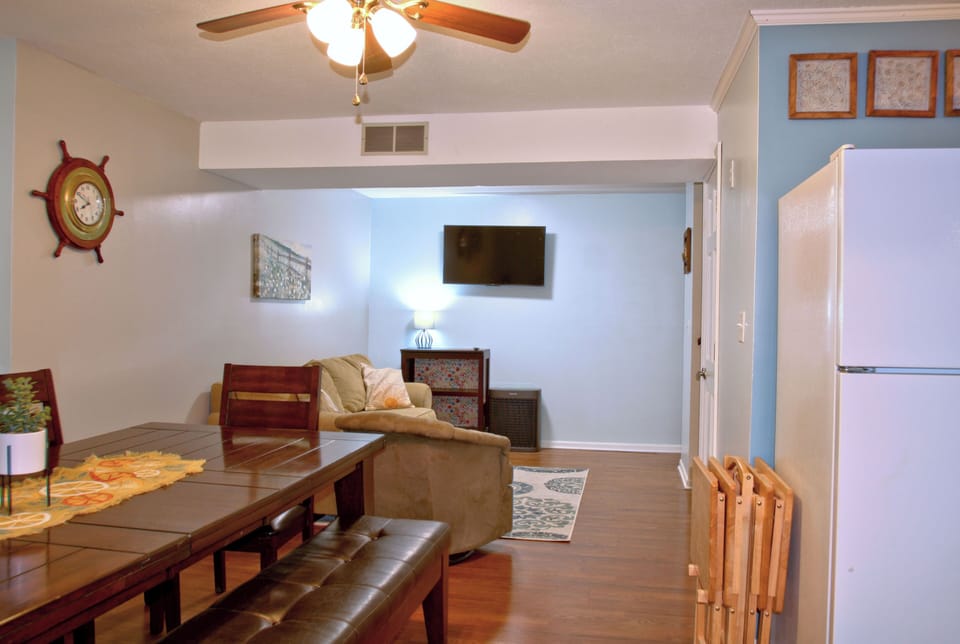 View from dining table towards steps, laundry and secondary living room.