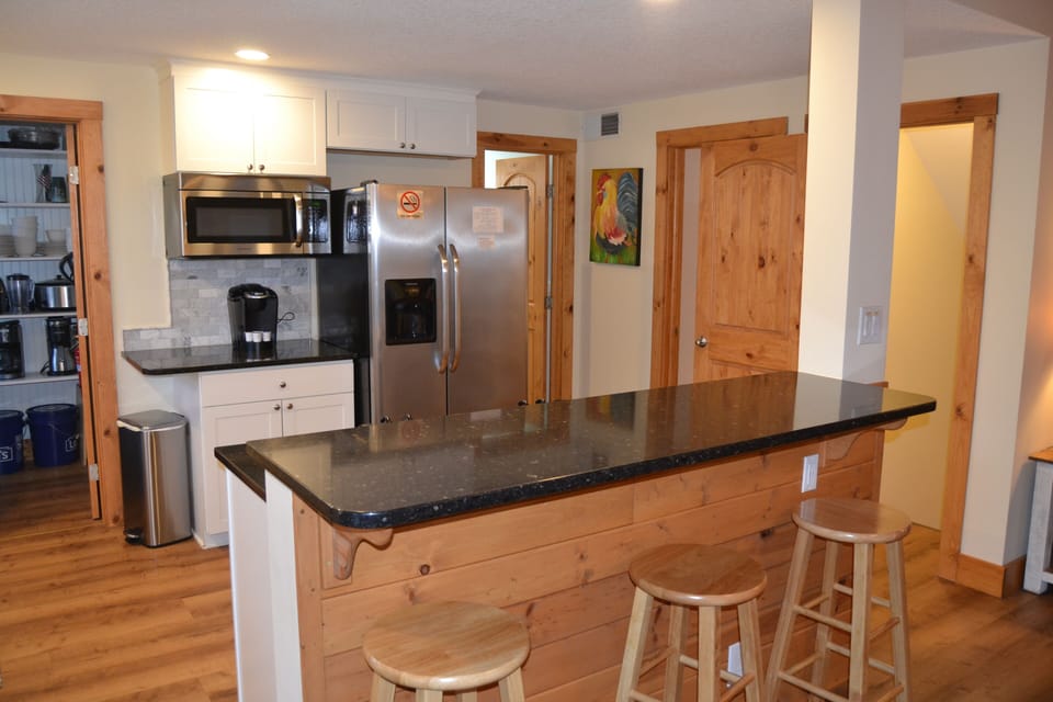 Lovely kitchen with island/bar with Pantry closet and more kitchen supplies