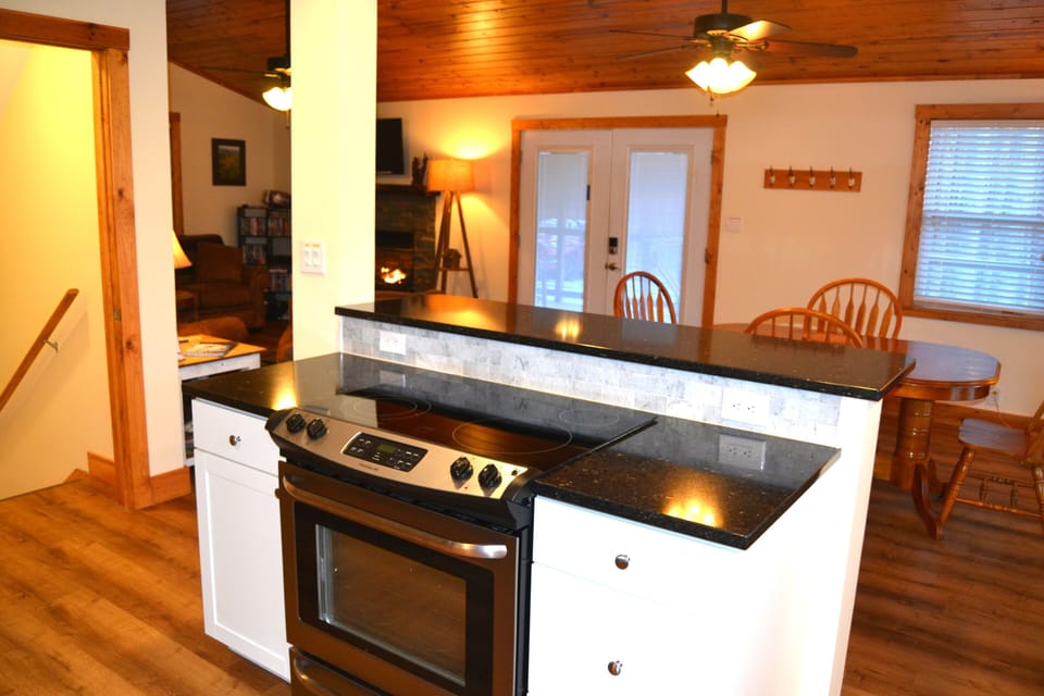 Kitchen island and bar with 3 stools. OPEN FLOOR PLAN for visiting & convenience