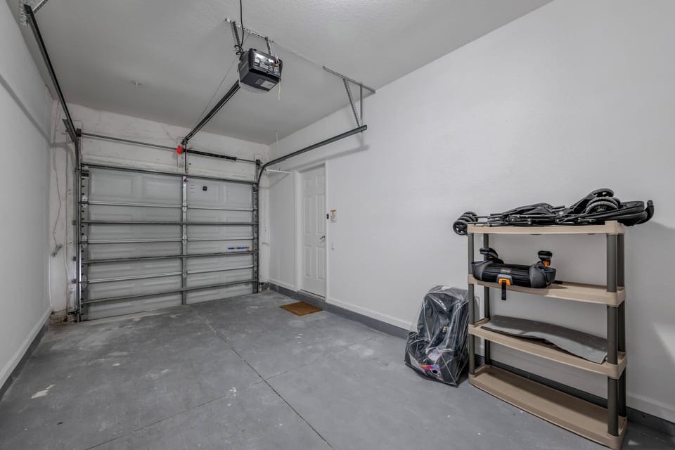 Laundry room with full size washer and dryer located in the garage