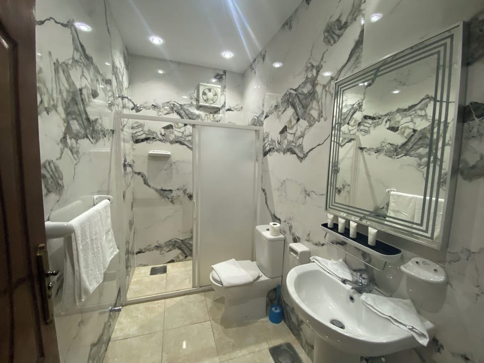 Deluxe Quadruple Room, Desert View | Bathroom | Shower, hair dryer, towels, soap