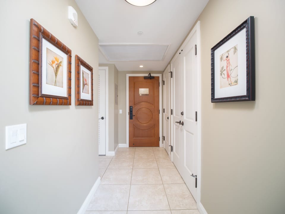 Step into elegance with this welcoming hallway adorned with tropical artwork and modern accents.