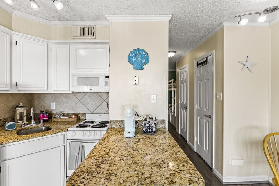 Cozy kitchen with granite countertops and a Keurig coffee maker
