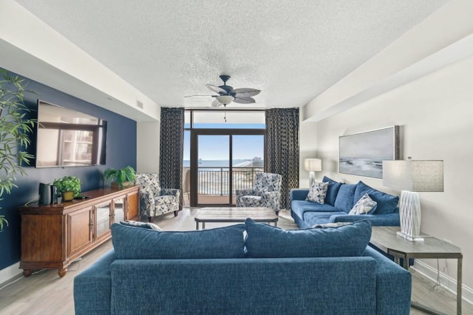 Relax in the comfort of a large well-appointed living room with an ocean view.