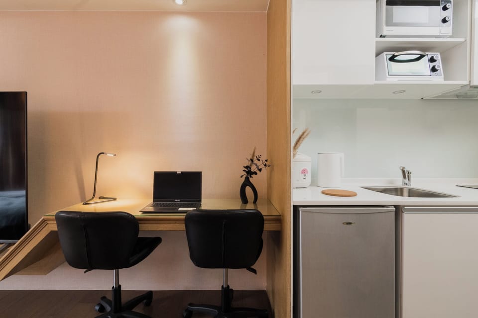 Bedroom Area:
• King Bed
• Closet
• 75" Smart TV
• Desk w/2 Office Chairs
