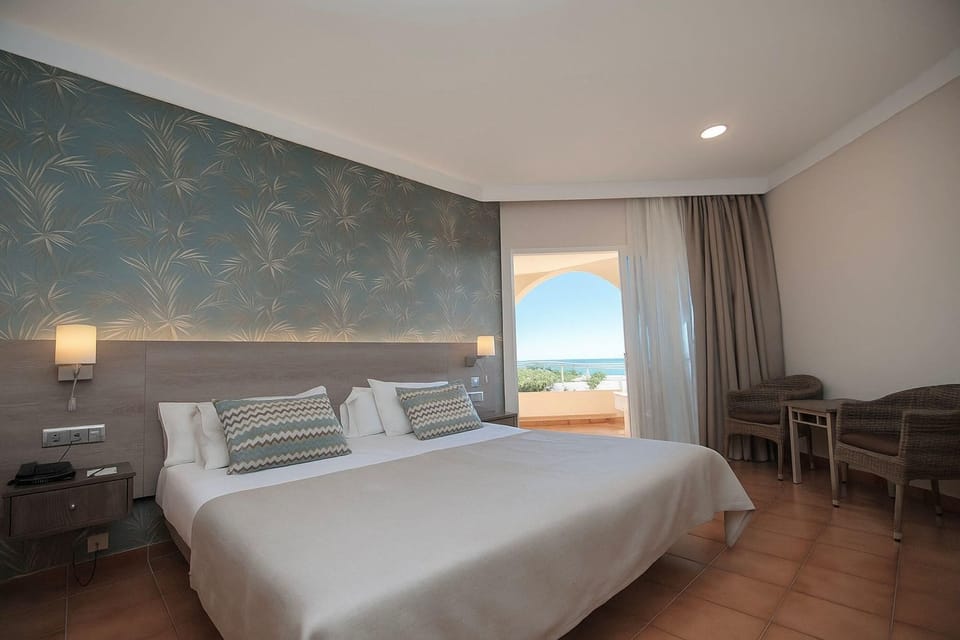Double Room, Sea View | Down comforters, minibar, desk, blackout drapes
