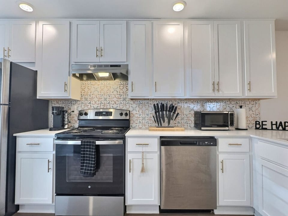 Ample cabinet storage and a clean countertop create an inviting atmosphere, perfect for meal preparation.