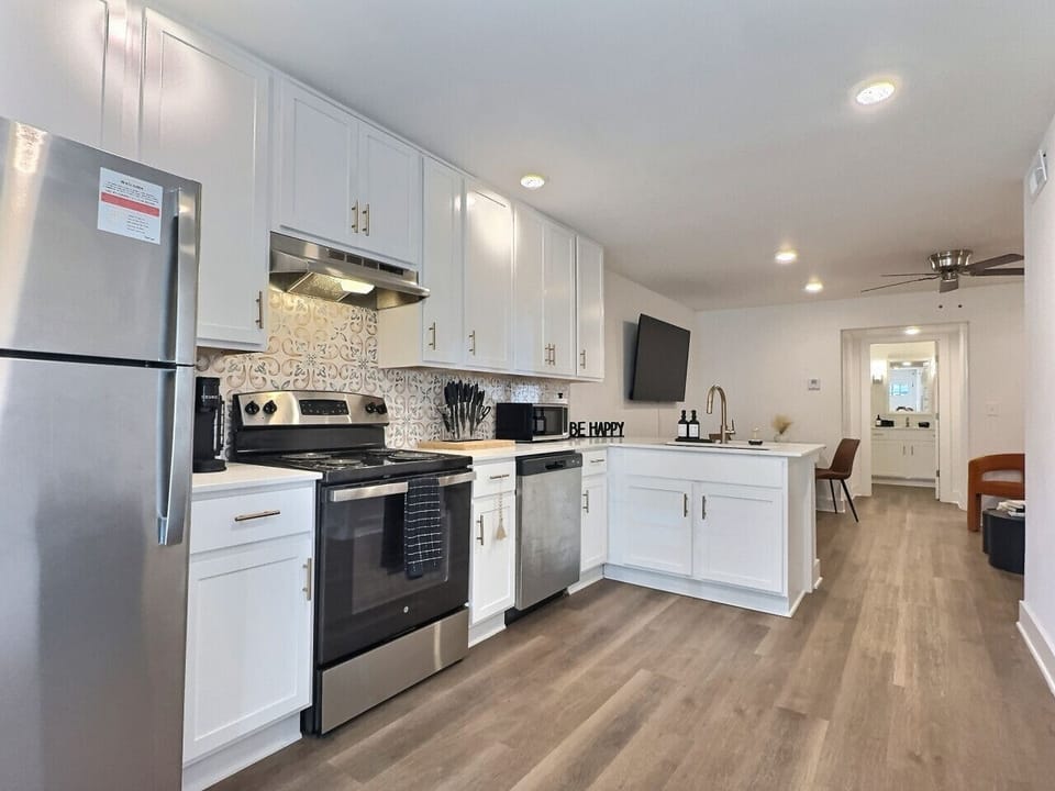 Equipped with a stainless steel oven, dishwasher, and microwave, this space ensures all your cooking needs are met effortlessly.