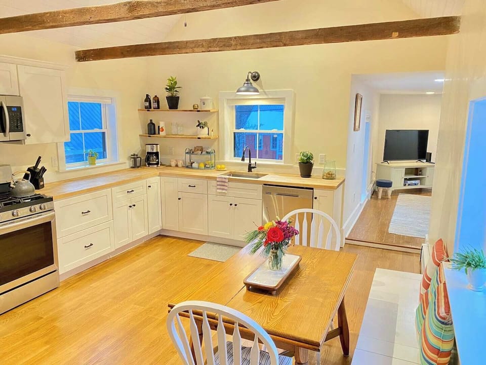 Kitchen with cathedral ceiling, all new appliances, butcher block countertops, and hardwood floors. 