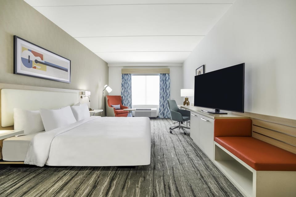 Room, 1 King Bed, Roll-in Shower | Blackout drapes, iron/ironing board, free cribs/infant beds, bed sheets