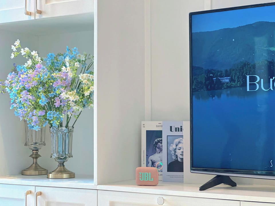 Deluxe Apartment, Partial Sea View | Living area | 32-inch Smart TV with cable channels