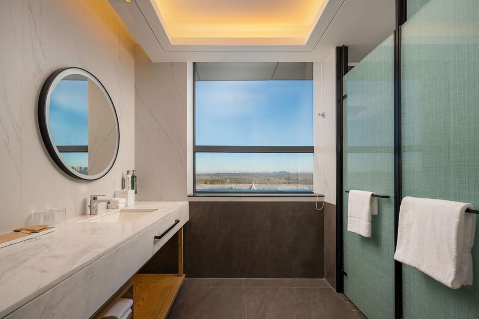 Deluxe Room, 2 Twin Beds | Bathroom | Rainfall showerhead, free toiletries, hair dryer, children's robes