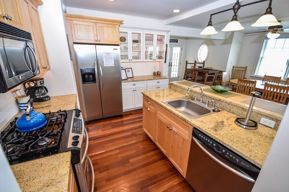 Another angle of the chef’s kitchen showcasing stainless steel appliances and ample counter space.