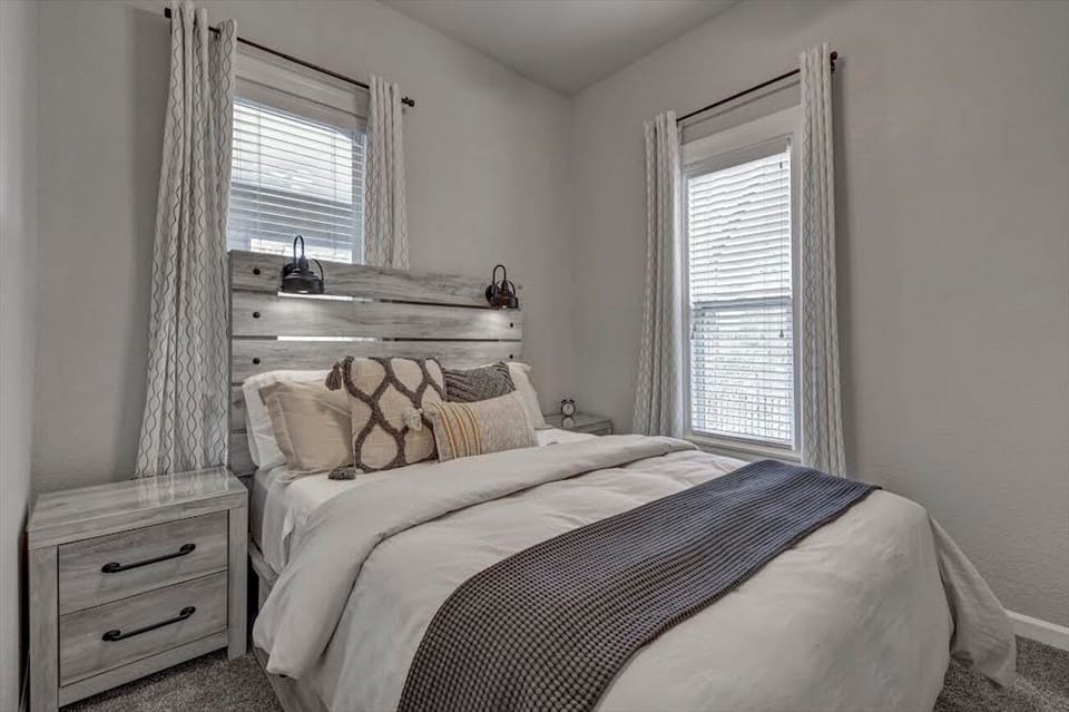 1st Bedroom has Queen Bed with drawers, reading lamps, a TV and closet