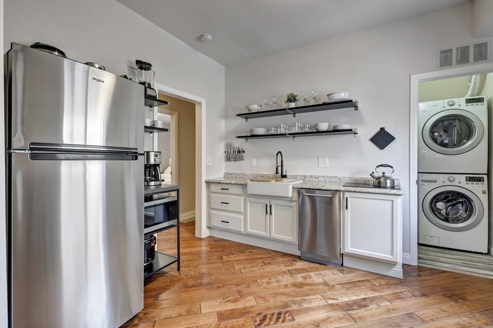 Kitchen is stocked well with pots, pans, appliances and dishes