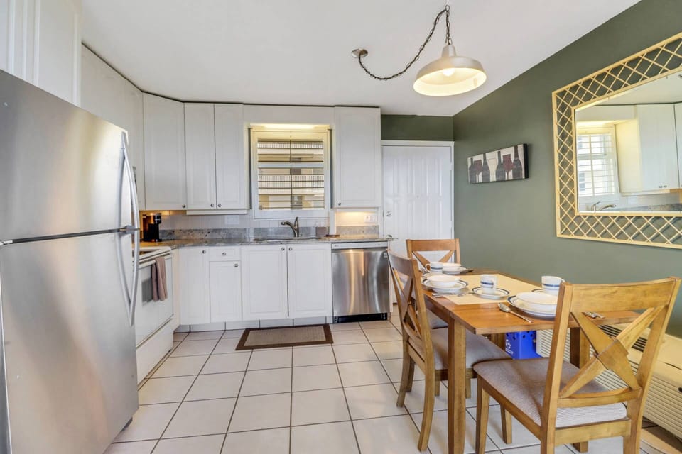 A drop-leaf dining table in the kitchen space has seating for 3, with additional folding chairs in the storage closet.