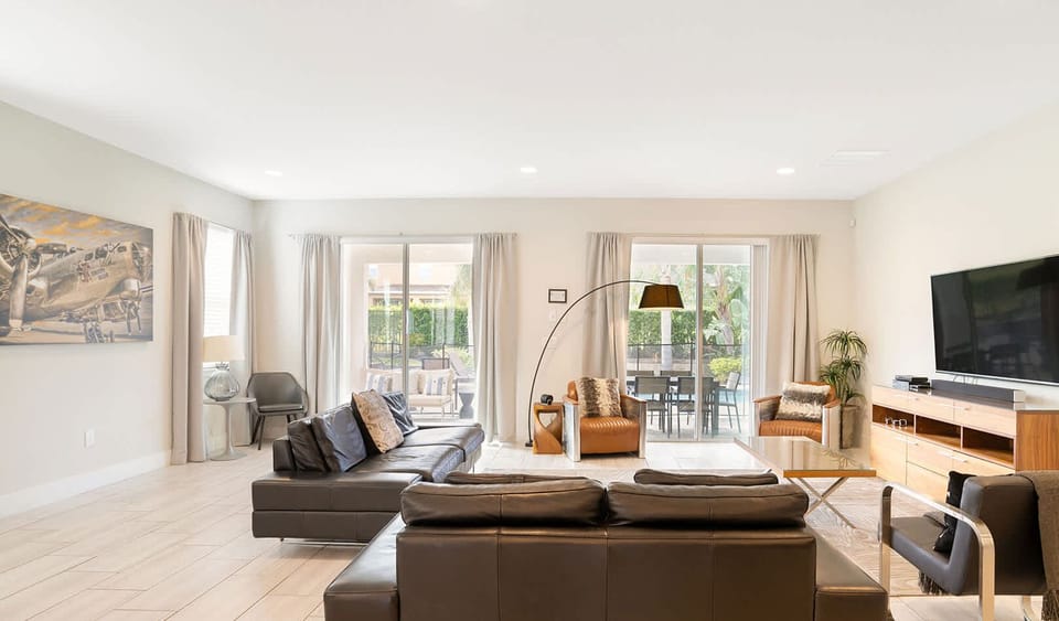 Relax in style in this spacious, modern living room with plenty of natural light.