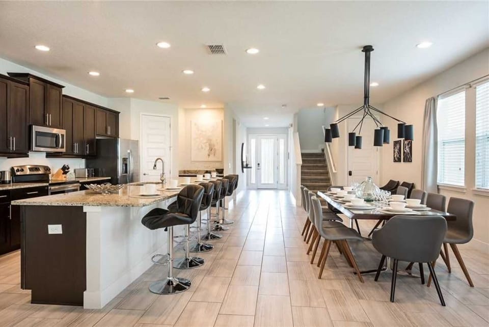 An enormous fully-equipped kitchen and beautiful dining area for meals at home.