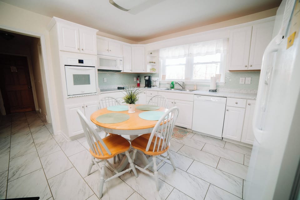 Modern kitchen with ample natural light and seating area