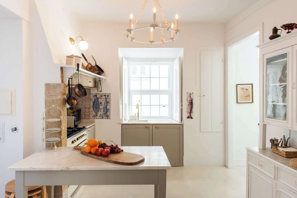 Santo Antonio 1 light-filled kitchen, featuring a large window and a charming island