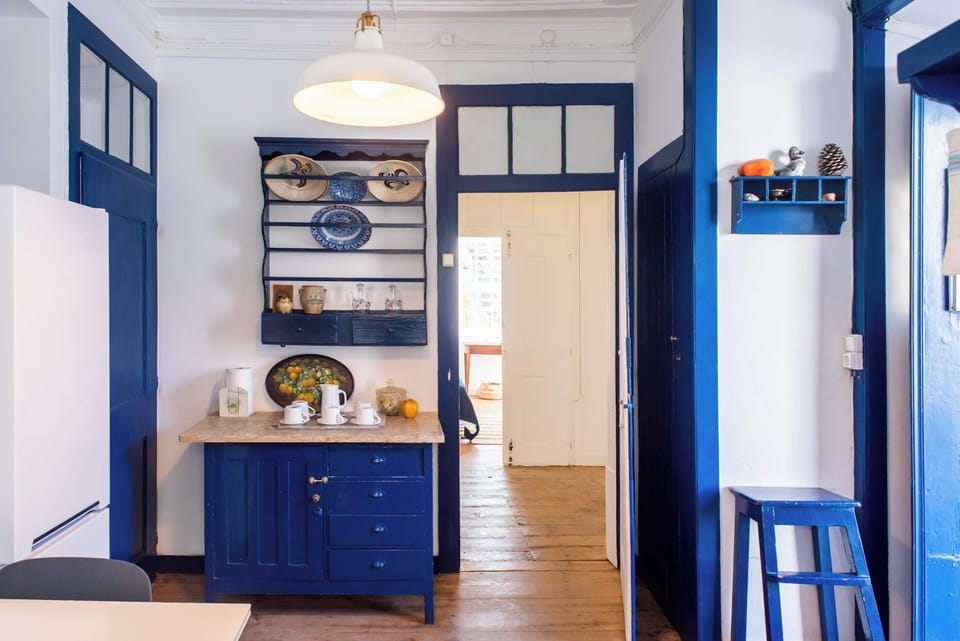 Santo Antonio 2 charming, cozy kitchen with rich navy blue cabinetry and vintage accents.
