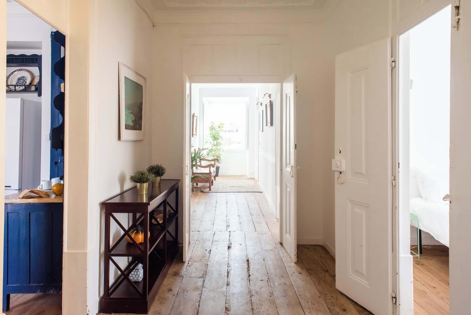Santo Antonio 2 sun-drenched hallway, bathed in natural light, showcasing a vintage-style entryway.