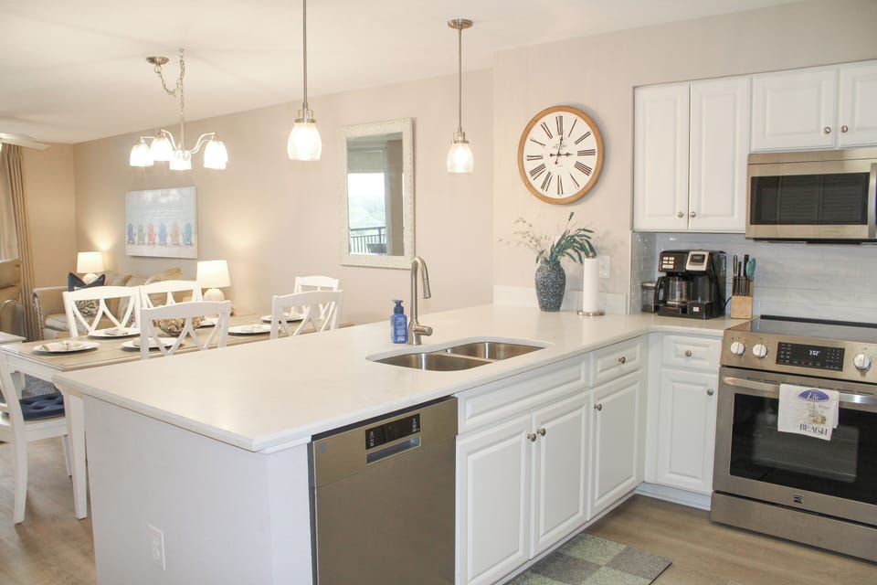Your bright, fully-equipped kitchen features granite counters, stainless appliances, and an island perfect for meal prep and morning coffee.