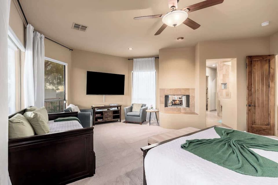 Your spacious suite blends bedroom and lounge seamlessly—a ceiling fan cools restful nights, a fireplace warms cozy evenings, and a big-screen TV keeps you entertained in style.